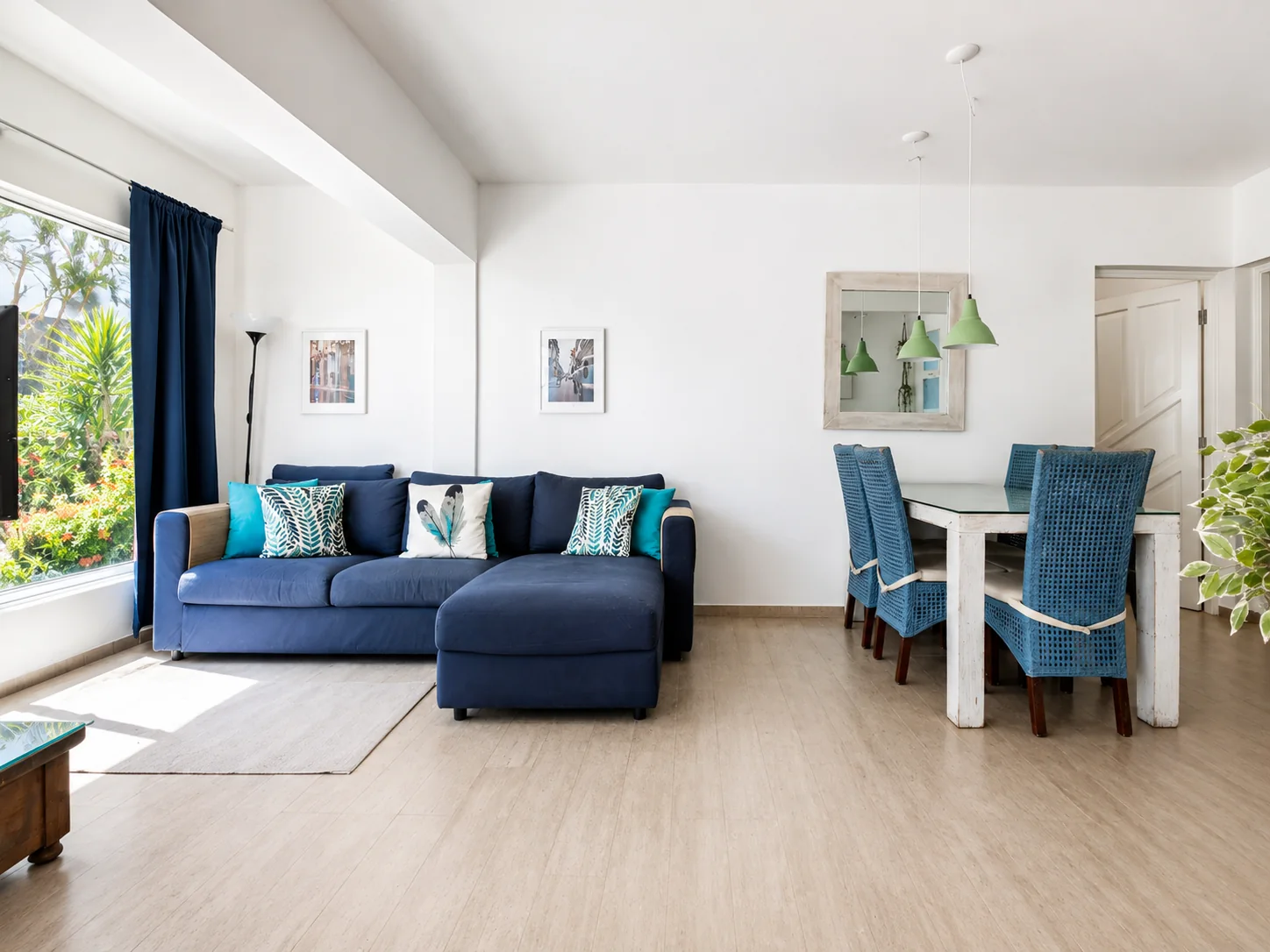 Living and dining area with sofa and bookshelves