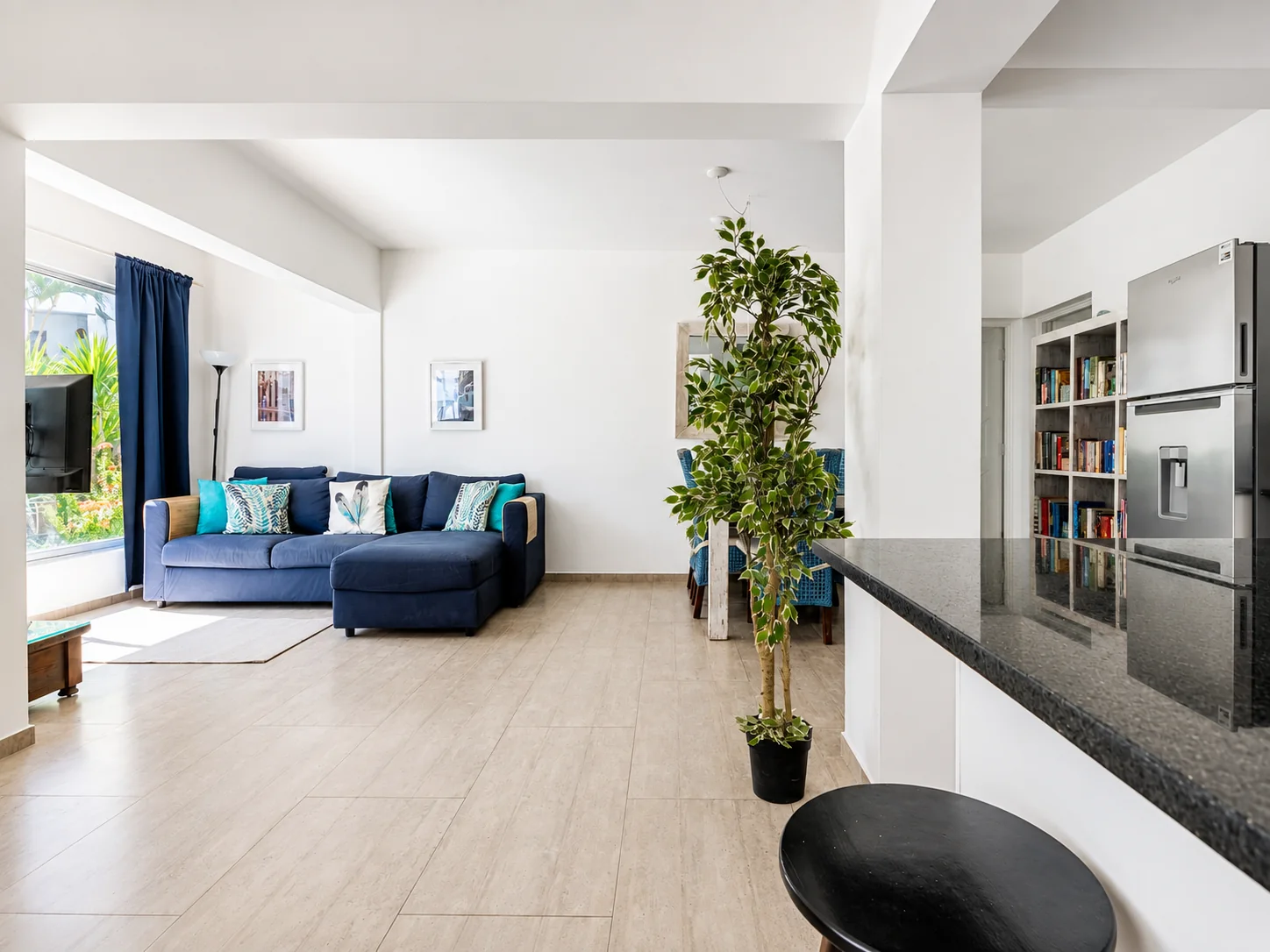 Bright open-plan living space with dining table and kitchen island