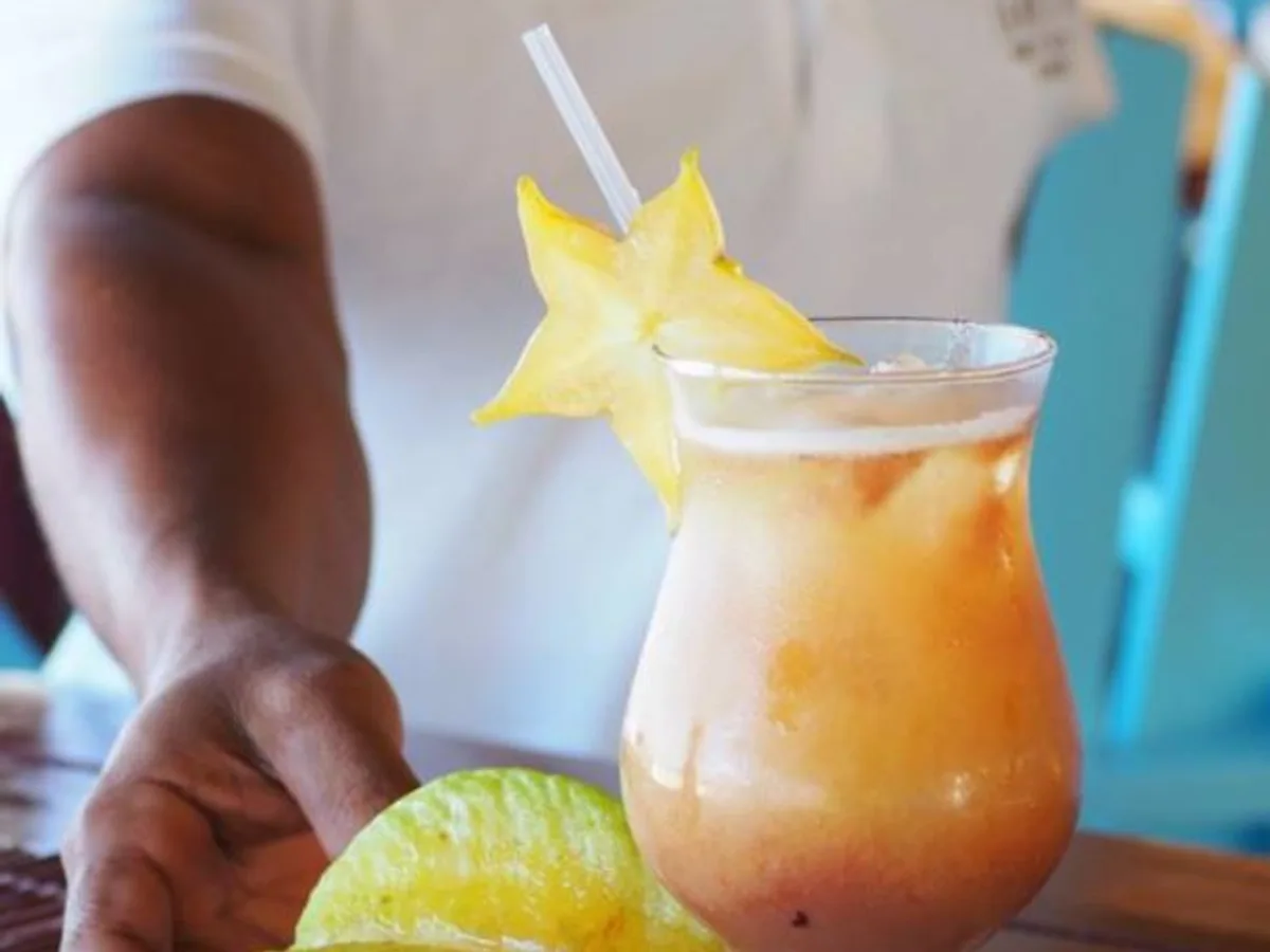 Tropical fruit cocktail with starfruit garnish served at La Mesa Taína, the onsite restaurant at Condo Cabrinha