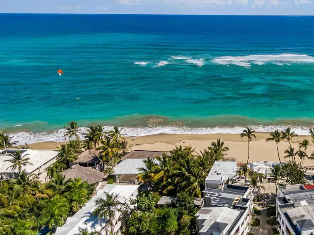 Aerial view of a kitesurfer on the turquoise water of Kite Beach, Cabarete
