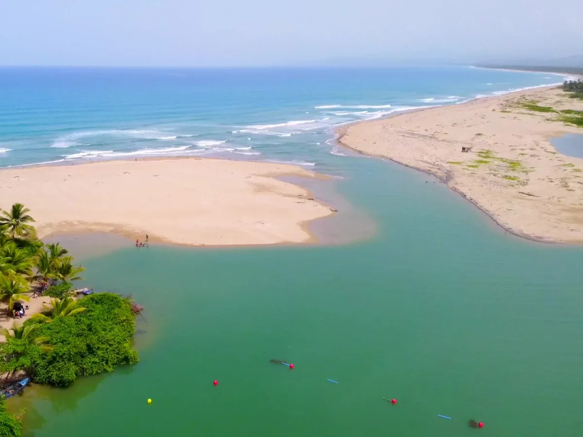 Aerial view of the La Boca river mouth meeting the ocean near Cabarete